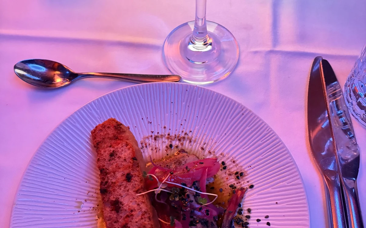 A laid dinner table beside the panoramic glass of a Seine cruise boat in Paris