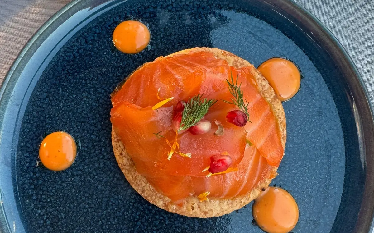 A glass-roofed dinner boat at the quayside below the Eiffel Tower in Paris