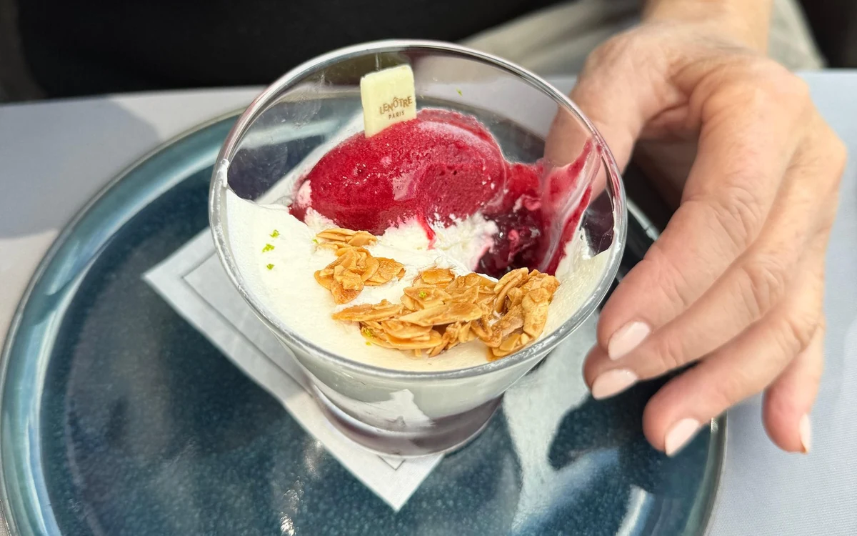 A glass-roofed lunch cruise boat on the Seine in Paris in daylight